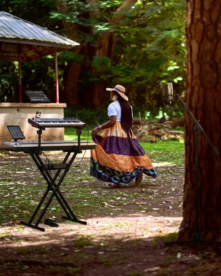 An outdoor worship session set up among the trees — keyboard, microphone and open air