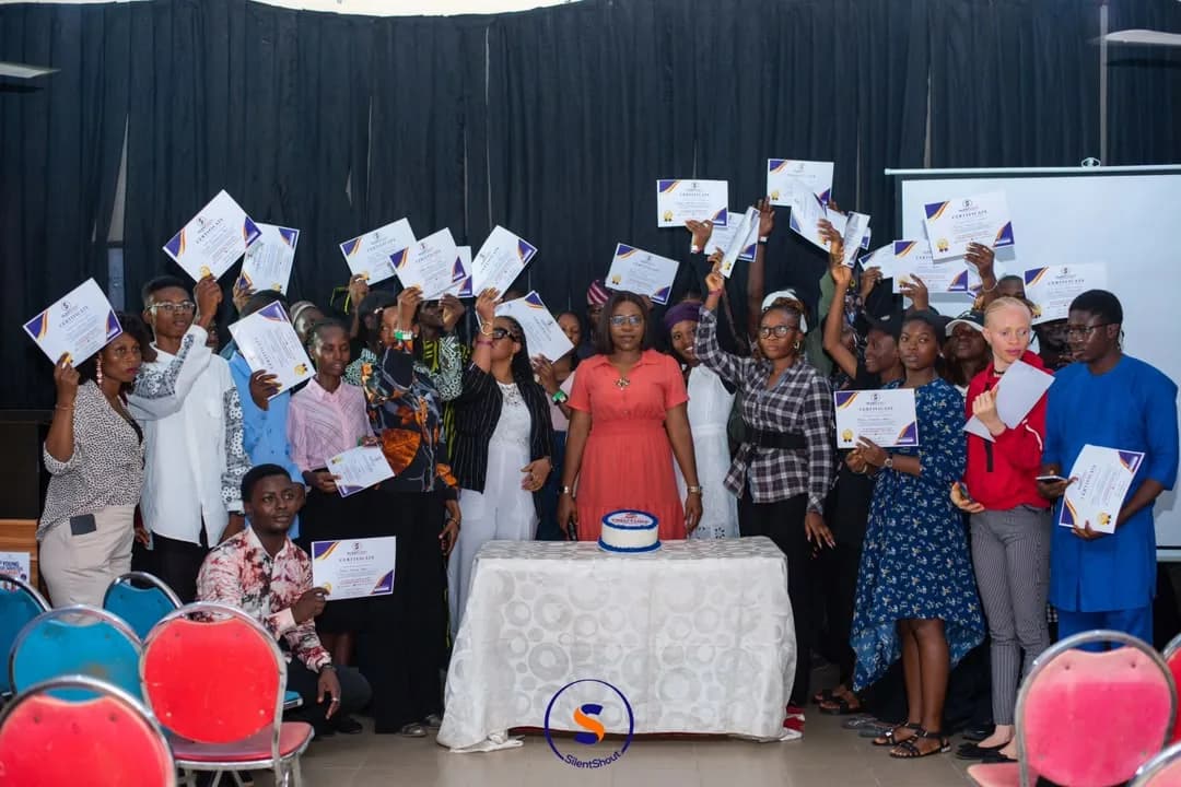 Participants holding up their certificates at a WUSH closing ceremony