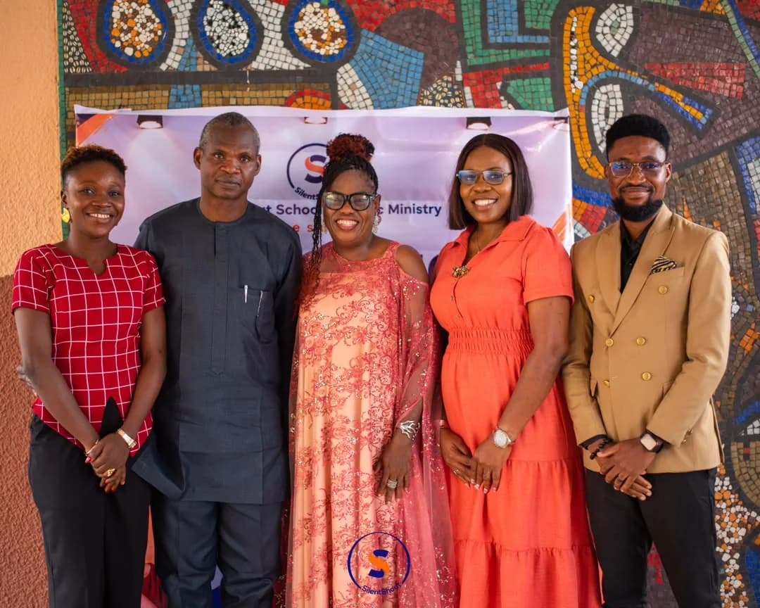 The SilentShout team in front of the School of Music Ministry banner