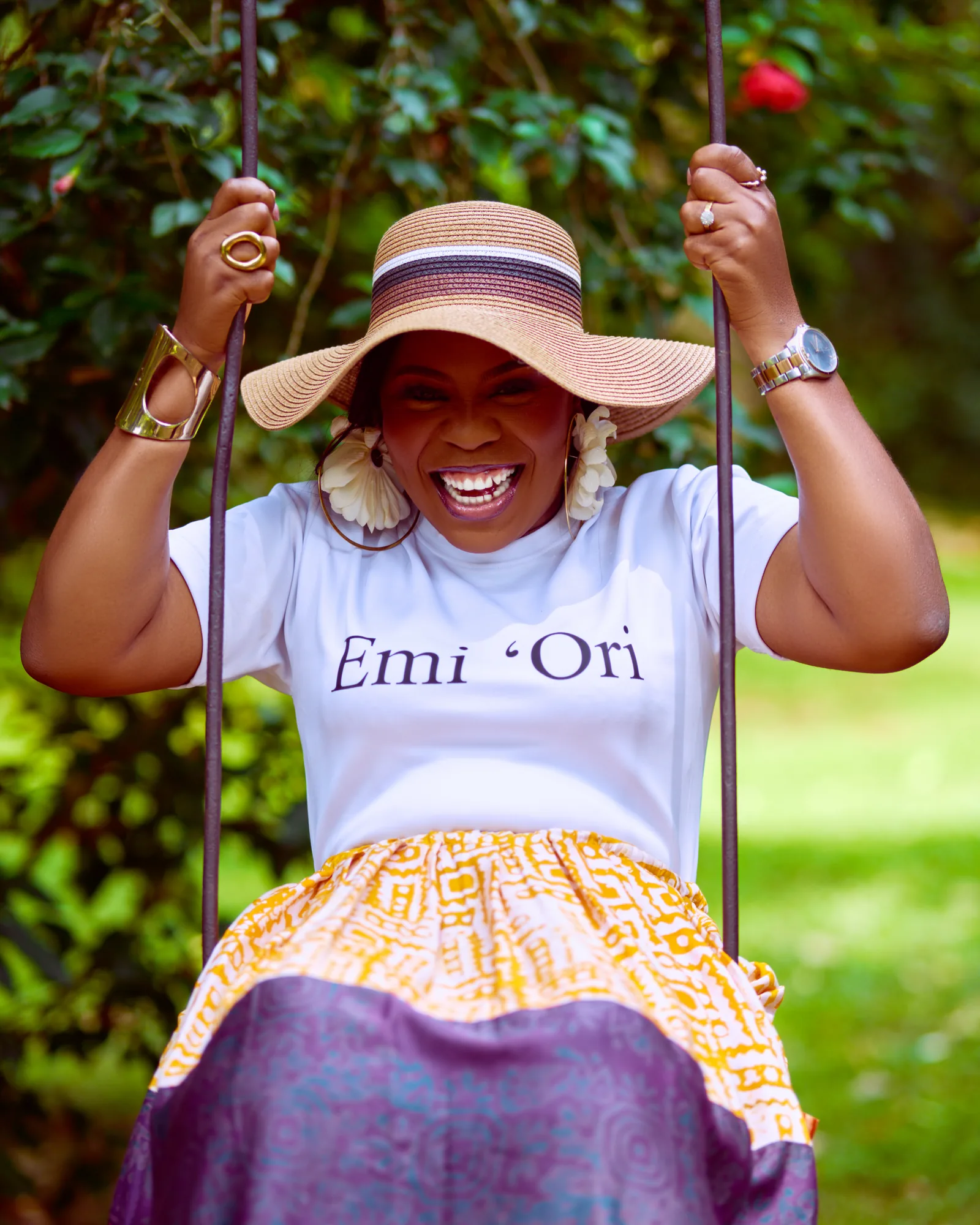 Ebahi laughing on a garden swing