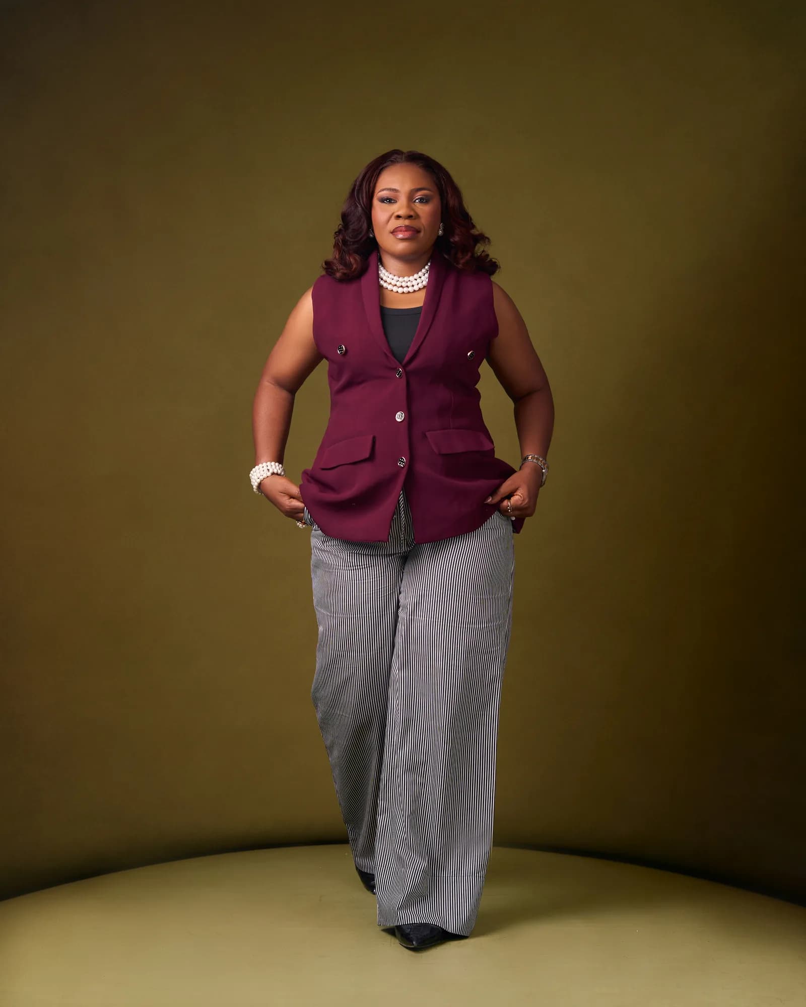 Ebahi in a burgundy jacket, full length